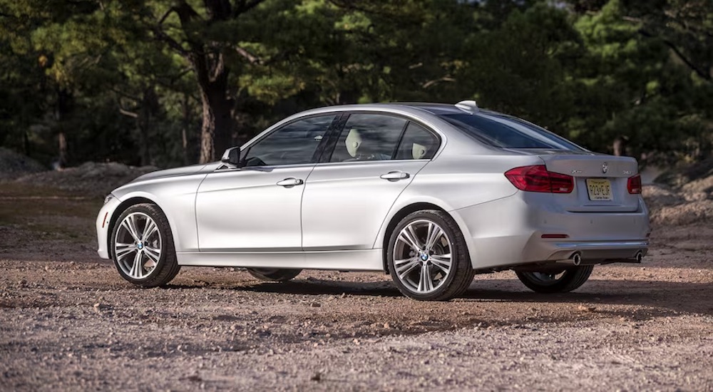 A silver 2018 BMW 3-Series parked in a rural area.