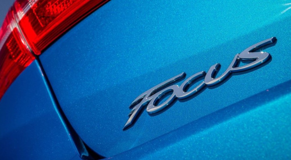 A close up of the Focus badge on a blue 2015 Ford Focus.