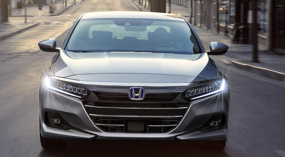 A close up of the grille on a silver 2022 Honda Accord Hybrid Touring, one of many used SUVs for sale.